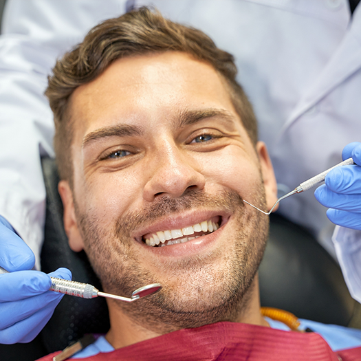 Smiling man with facial hair in dental chair