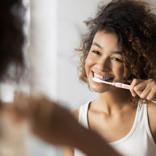 Patient in Melbourne brushing their teeth