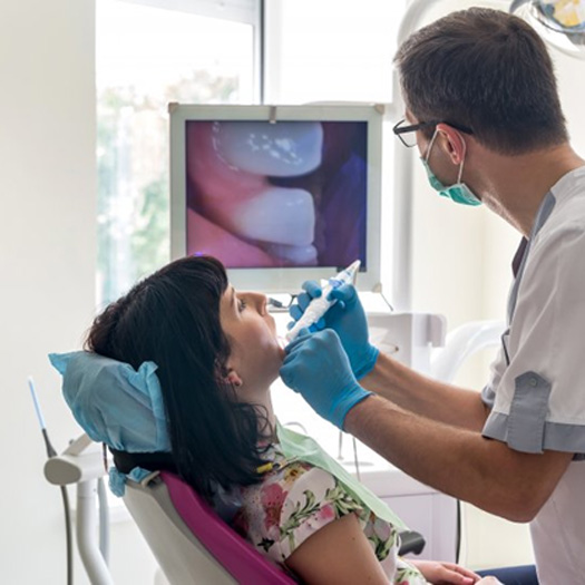 Melbourne dentist examining a patient's teeth during a routine dental checkup 