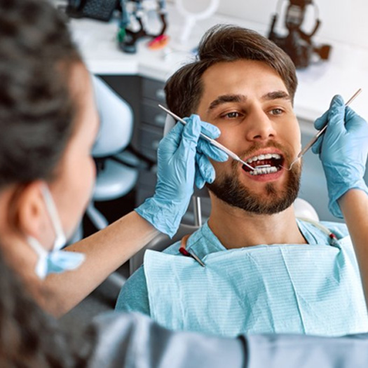 Dental hygienist performing a teeth cleaning for a patient in Melbourne