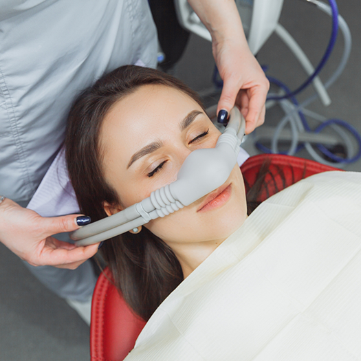 Woman having nasal mask placed for nitrous oxide sedation