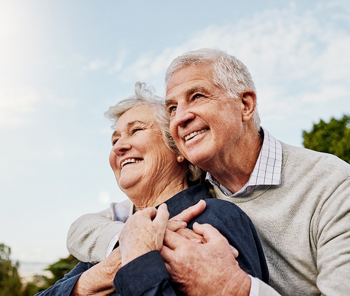 An elderly couple looking up toward the sky