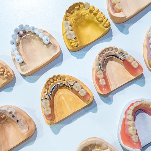 Various types of dentures against a blue background