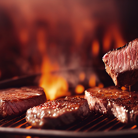 Steaks being cooked on a grill