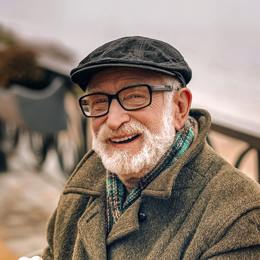 Bearded senior man with hat and glasses
