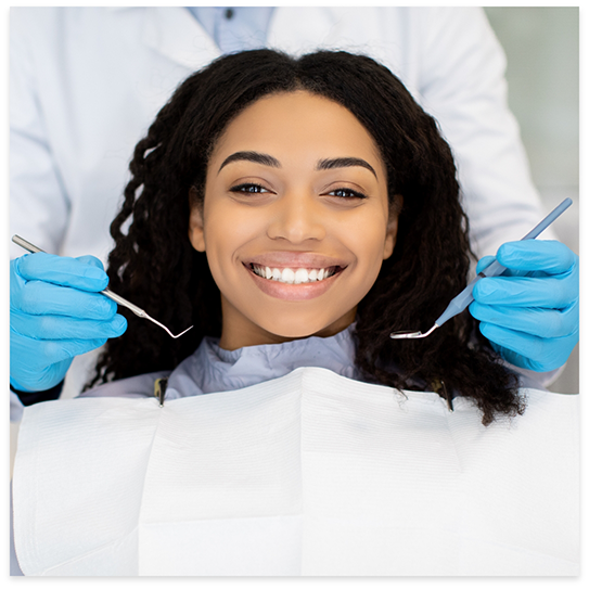 Smiling woman sitting in dental chair smiling