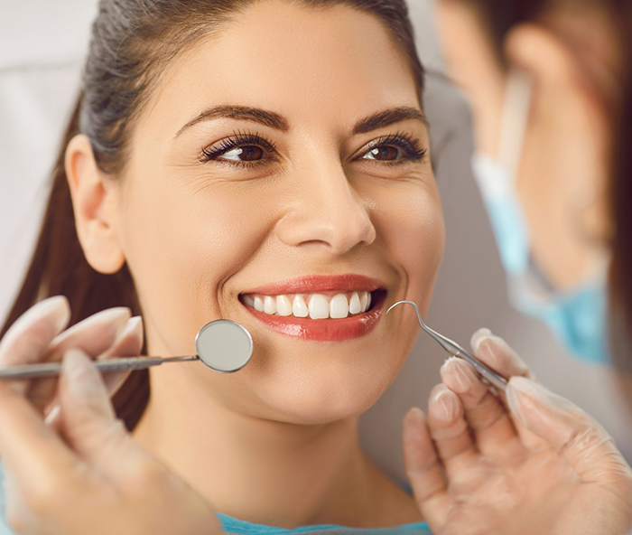 Woman having her teeth examined by dentist