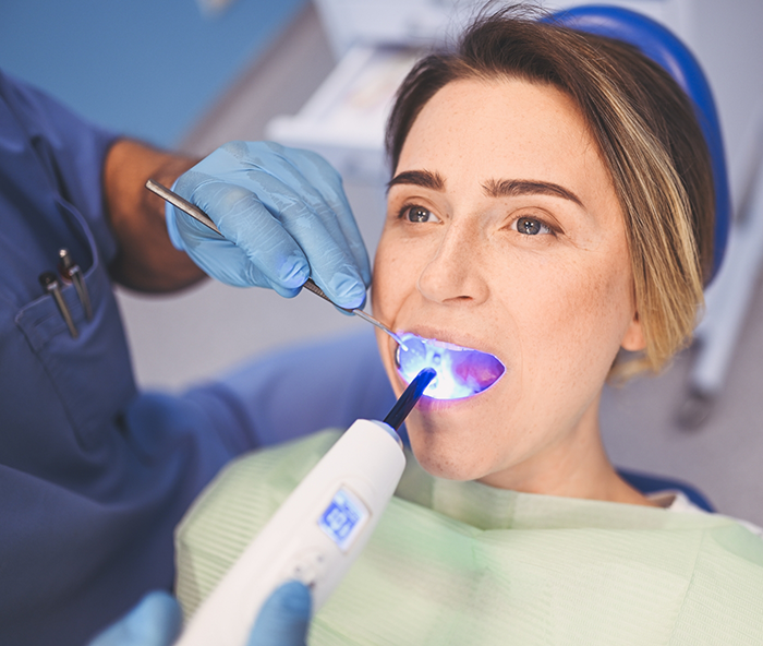 Female patient having dental filling placed