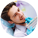 Male dental patient having teeth shade matched